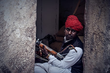man holding musical instrument at daytime thumbnail