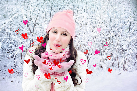 woman in pink knit cap and winter jacket on snowy place during daytime thumbnail