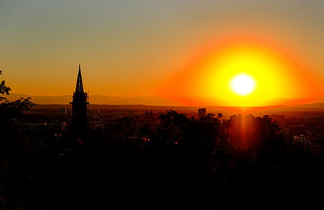 sunset over the city with tower thumbnail