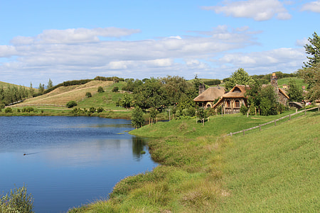 beige house near body of water thumbnail