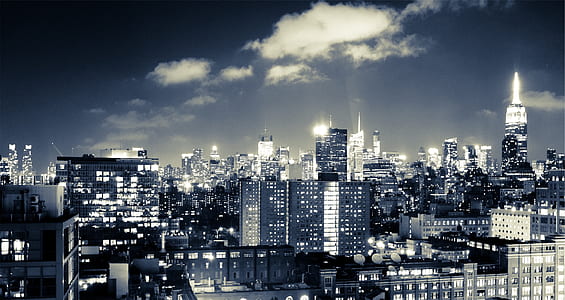 gray and white buildings under cloudy sky thumbnail