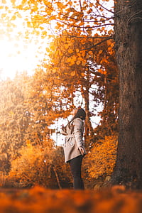 woman standing under tree thumbnail