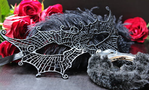 black masquerade mask surrounded by red Rose flowers thumbnail