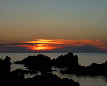 landscape photography of seashore and rock formations at sunset thumbnail