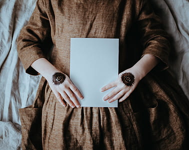 woman laying on bed holding printer paper thumbnail