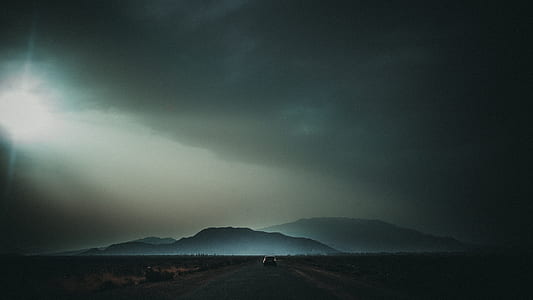 vehicle on road running towards mountain thumbnail