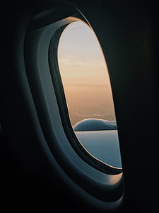 airplane window showing sky thumbnail