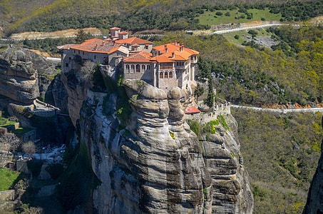 gray and orange mansion on top of mountain thumbnail
