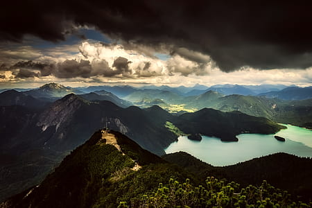 landscape photo of body of water surrounded by mountain thumbnail