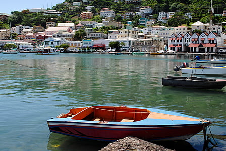 blue and brown wooden boat near dock during daytime thumbnail