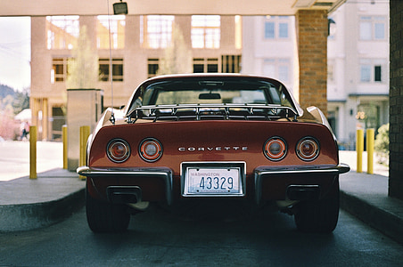 brown and black Chevrolet Corvette inside parking area thumbnail