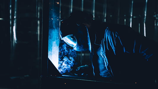man doing welding at night thumbnail