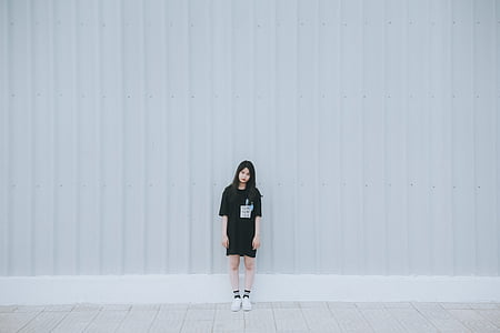 woman standing in front of wall thumbnail