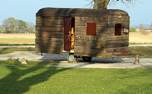 green camper trailer beside green tree thumbnail