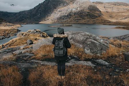 person standing behind of rock thumbnail