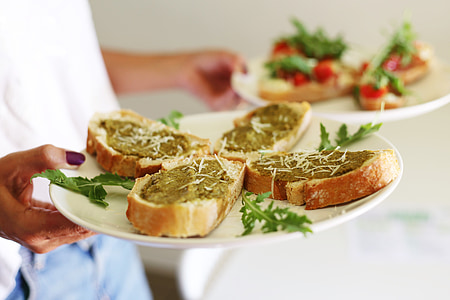 person holding plate filled with bread dish thumbnail