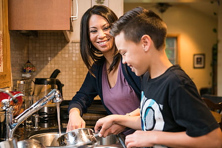 Mother And Son Washing Dishes Photo thumbnail