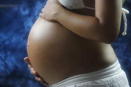 pregnant woman touching her tummy thumbnail