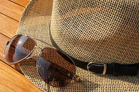 Brown Strawhat Beside Brown Aviator Sunglasses thumbnail