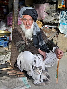 man wearing black turban holding orange tesbih thumbnail