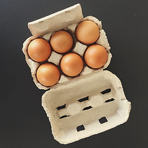 six brown organic eggs in tray thumbnail