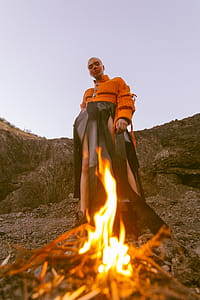 Man Wearing Orange Long-sleeved Shirt and Black Bottoms thumbnail