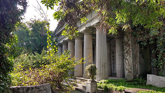 ruins of Greek structure surrounded by trees thumbnail