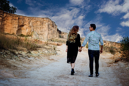 man and woman walking while holdiing hands thumbnail