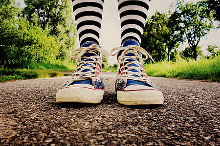 person wearing pair of red-and-blue high-top shoes thumbnail