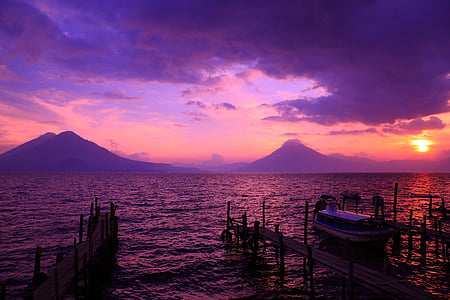 silhouette photo of body of water during sunset thumbnail