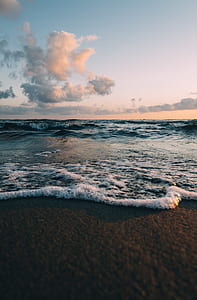 body of water under cloudy sky at daytime thumbnail