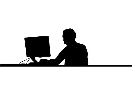 silhouette of man in front of monitor thumbnail
