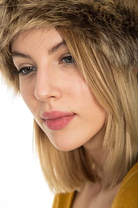 woman wearing brown cap looking downwards thumbnail