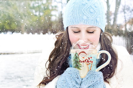 woman holding christmas-themed mug during daytime thumbnail