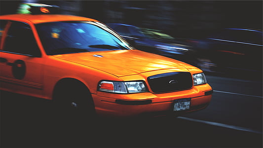 selective focus photography of yellow Ford Crown Victoria on concrete road thumbnail