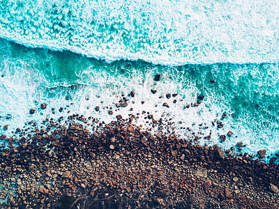 aerial photo of ocean waves through shore at daytime thumbnail