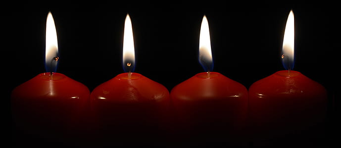 four red lighted candles thumbnail