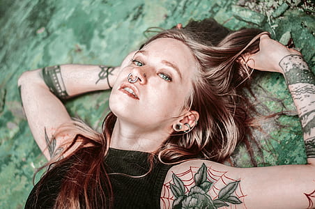 lying woman on green grass field thumbnail