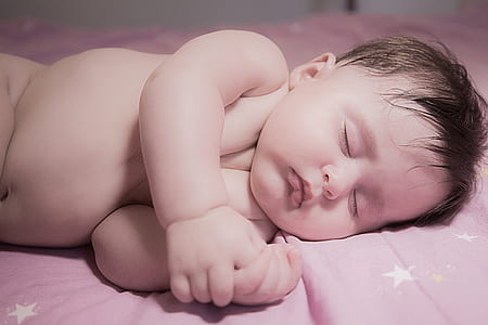 sleeping baby on pink and white star graphic sheet thumbnail