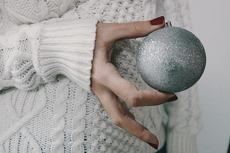 Person holding a silver Christmas decoration ball thumbnail