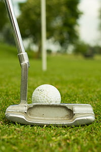 grey golf putter and white gold ball on green grass selective-focus photography at daytime thumbnail