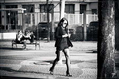 woman walking beside tree thumbnail