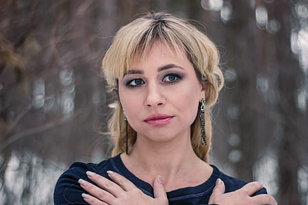 shallow focus photography of woman wearing black crew-neck top thumbnail