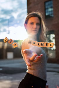 shallow focus photography of scrabble tiles over woman's palm thumbnail