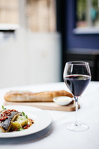 clear wine glass near bread and plate thumbnail