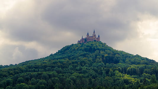 pink castle on top of hill thumbnail