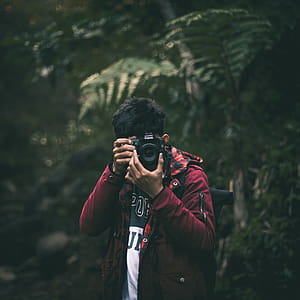 Photo of Man Holding a Camera thumbnail