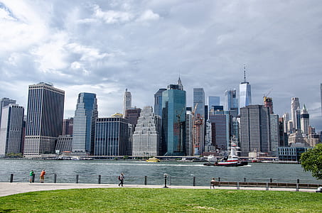 landscape photography of high-rise commercial buildings near ocean water during daytime thumbnail