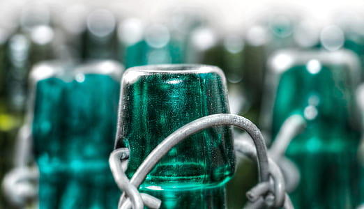 focus photography of blue glass bottle lip thumbnail