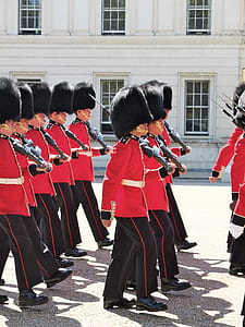 royal guards marching near white building thumbnail